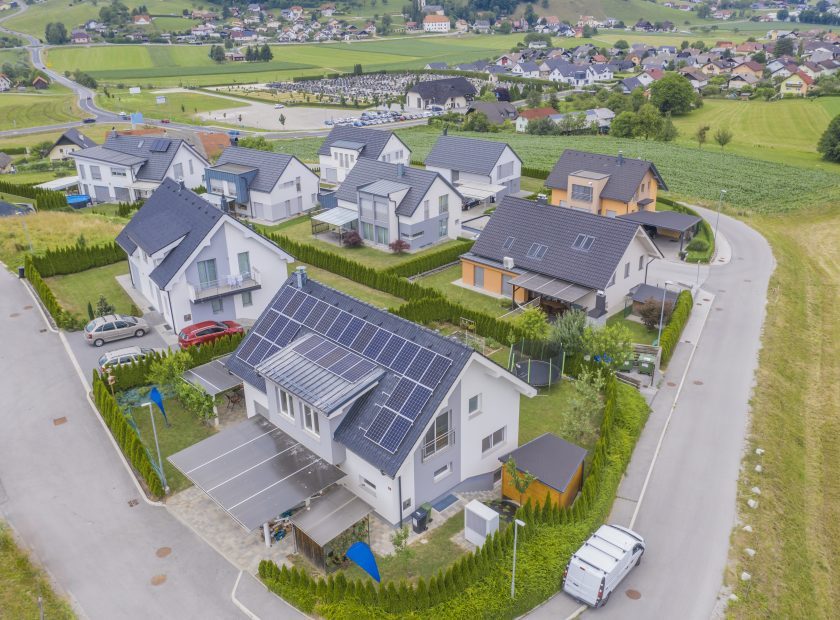 High angle shot of private houses with solar panels on the roofs