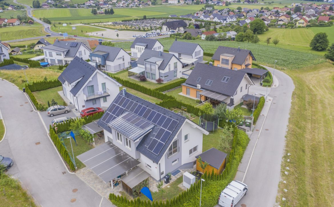 High angle shot of private houses with solar panels on the roofs